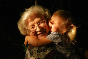 An older woman and a young girl enjoying a heartfelt hug