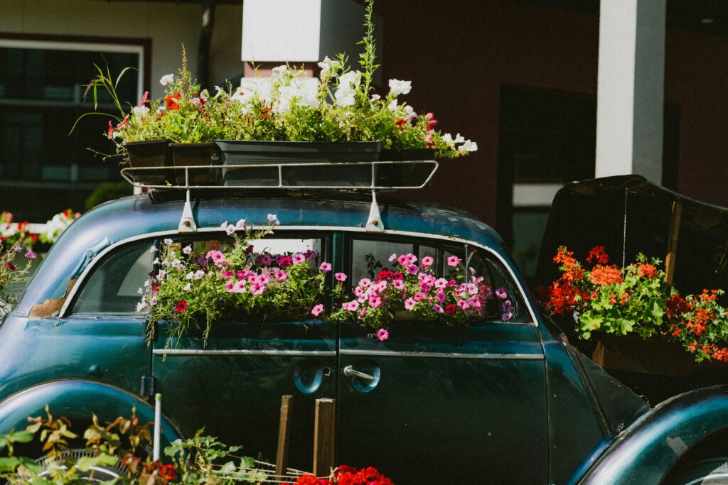 Car adorned with flowers for a customized funeral procession, highlighting a personal and meaningful tribute.